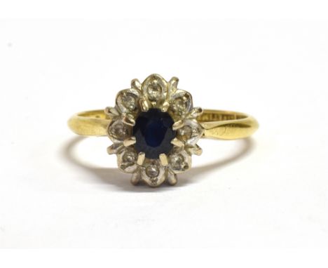 AN 18CT GOLD PARAIBA AND DIAMOND FLOWER HEAD RING The blue Paraiba measuring 0.5cm x 0.4cm in a bed of white metal, most prob