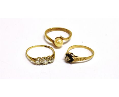 THREE 9CT GOLD RINGS A cultured pearl solitaire ring, ring size N ½ weight 2g, a clear glass triple stone dress ring, size N,