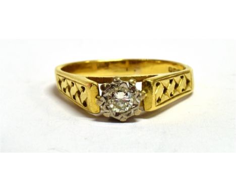 A VINTAGE 18CT GOLD DIAMOND RING The round cut diamond measuring approx. 0.25cm in diameter in a white metal setting on a yel