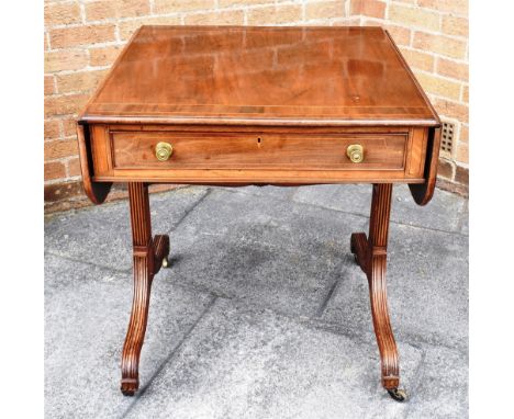 A VICTORIAN SOFA TABLE  with crossbanded and inlaid decoration, single frieze drawer on sabre legs, 110cm wide with both leav