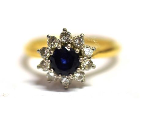 A SAPPHIRE AND DIAMOND FLOWER HEAD RING Sapphire measurement 0.5cm shank marked 18ct PLAT Ring size N ½ weight 4.6g, flower h