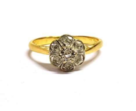 A DIAMOND SET FLOWER HEAD RING Shank with faded 18 or 15ct marking, ring size O, weight 3.2g