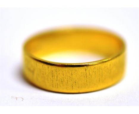 A 22CT GOLD BAND RING The band with textured pattern band width 0.5cm, size P ½  weight 5.6g