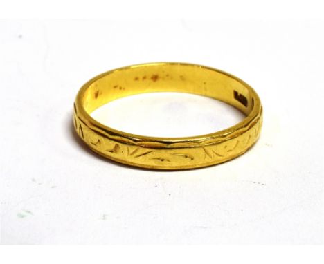 AN 18CT GOLD ENGRAVED PATTERN BAND RING The ring with faded hallmark, band width 0.4cm, ring size S, weight 3.4g