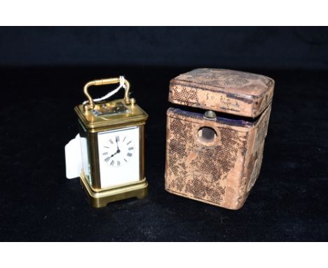 A MINATURE BRASS CARRIAGE CLOCK the unsigned enamel dial withRoman numerals, French movement numbered 26416, 8cm high with ha