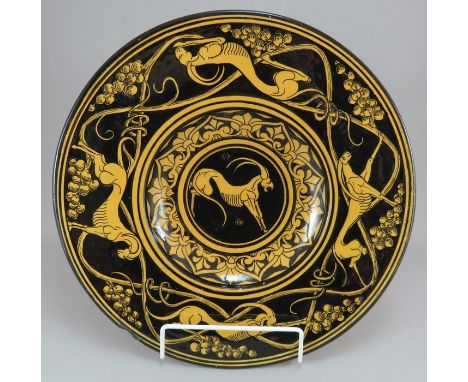 An early twentieth century Italian M F Faenza circular ceramic wall plaque, c. 1910. It is decorated in black on a yellow gro