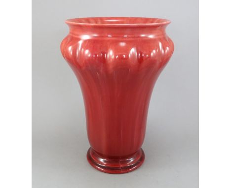 An early twentieth century Royal Lancastrian ox-blood red shaped vase with splayed neck, c.1910-20. It is impressed with the 