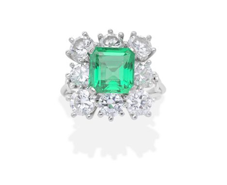 EMERALD AND DIAMOND CLUSTER RINGThe step-cut emerald within a brilliant-cut diamond surround, diamonds approx. 2.60cts total,