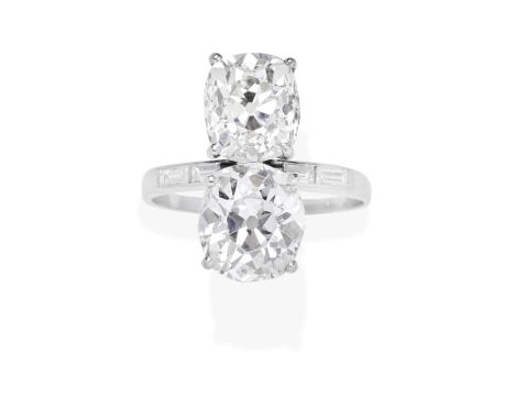 DIAMOND TWO-STONE RINGEach cushion-shaped diamond weighing 3.25 carats or 3.35 carats, between baguette-cut diamond shoulders