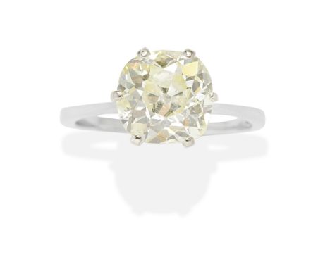 COLOURED DIAMOND RINGThe cushion-shaped diamond of yellow tint, weighing 2.87 carats, diamond untested for colour origin, rin