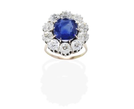 SAPPHIRE AND DIAMOND RING, LATE 19TH CENTURYThe cushion-shaped sapphire, within an old brilliant-cut diamond surround, mounte