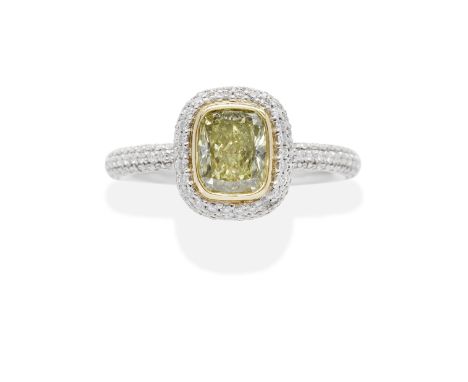 TIFFANY: FANCY COLOURED DIAMOND AND DIAMOND RINGThe cushion-shaped Fancy Intense Yellow diamond weighing 1.24 carats, within 