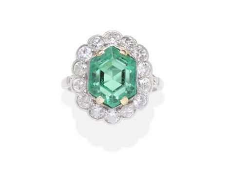 EMERALD AND DIAMOND RINGThe hexagonal-cut emerald, weighing 6.38 carats, within an old brilliant-cut diamond surround, diamon