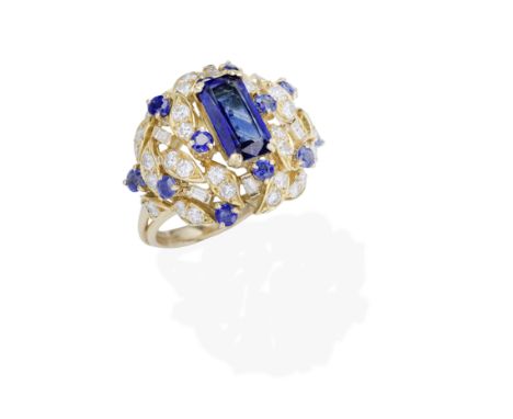 SAPPHIRE AND DIAMOND CLUSTER RINGThe step-cut sapphire set within a circular-cut sapphire, baguette and brilliant-cut diamond