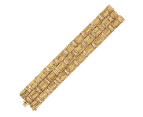 ROBERTO COIN: BRACELETBicoloured, of woven design, the clasp set with a step-cut ruby,  signed Roberto Coin, partial UK hallm