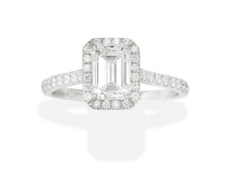 TIFFANY: DIAMOND SINGLE-STONE RINGThe emerald-cut diamond weighing 1.03 carats, with a brilliant-cut diamond surround and sho