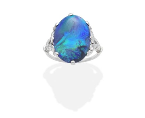 BLACK OPAL AND DIAMOND RINGThe opal cabochon, between single-cut diamond shoulders, ring size approx. I½For further informati