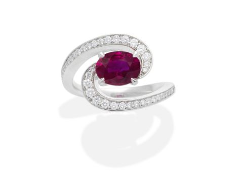 RUBY AND DIAMOND RINGThe oval-cut ruby within a brilliant-cut diamond swirl surround,    ruby approx. 1.55cts, ring size appr