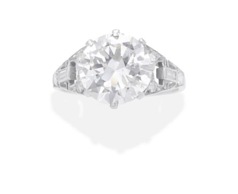 DIAMOND RING, EARLY 20TH CENTURYThe old brilliant-cut diamond, weighing 3.09 carats, between openwork baguette and brilliant-