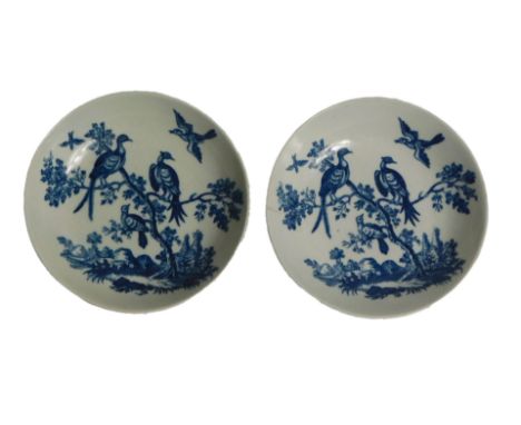 A pair of late 18thC Worcester porcelain saucers, printed on blue with birds in branches pattern, under glazed blue, hatched 