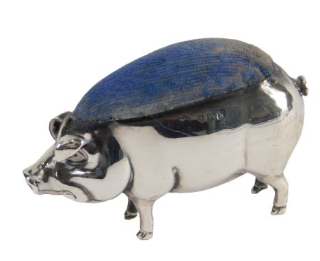 An Edwardian silver pin cushion, modelled in the form of a pig with velvet pad, London 1903.
