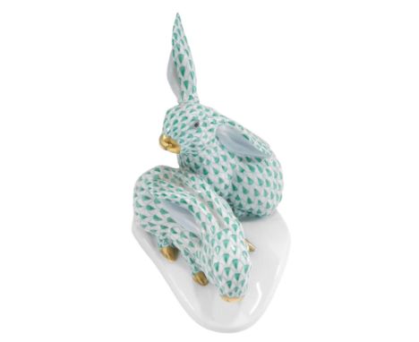 A Herend porcelain group of two rabbits, with green decoration, on shaped base, printed mark to underside, 13cm wide. 