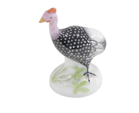 A Herend porcelain model of a guinea fowl, on oval base, 7cm high. 