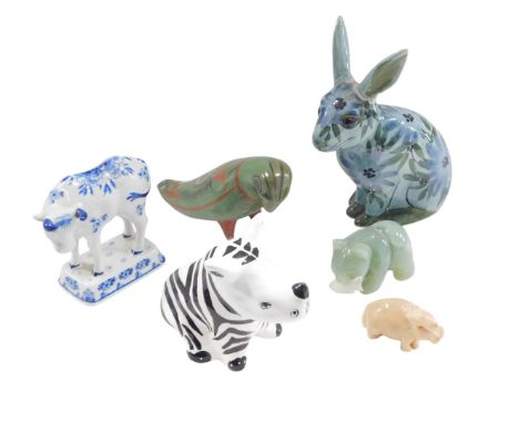 A collection of ceramic and hardstone animals, to include a bear with fish, South African rhino, rabbit, (AF), Delft cow, etc
