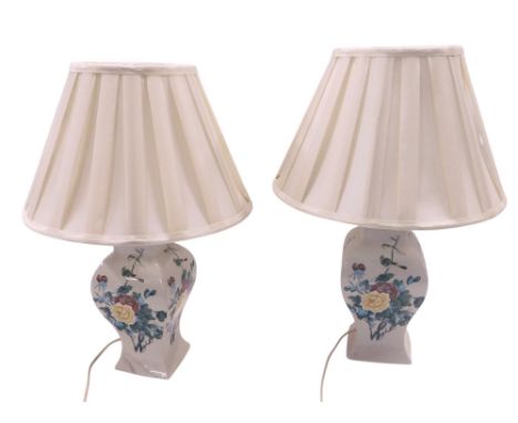 A pair of ceramic table lamps, each with printed decoration of flowers and birds, with pleated shade, 54cm high. WARNING! Thi