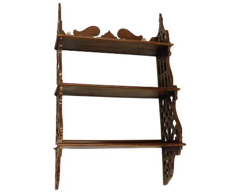 A mahogany wall cupboard, in Chippendale style, with three shelves, flanked by pierced gothic style supports, 83cm high, 52cm