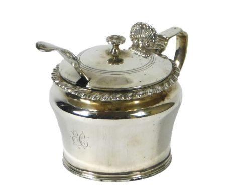A William IV silver mustard pot, with a gadrooned edge, shell cast thumb piece and blue glass liner, with an associated spoon