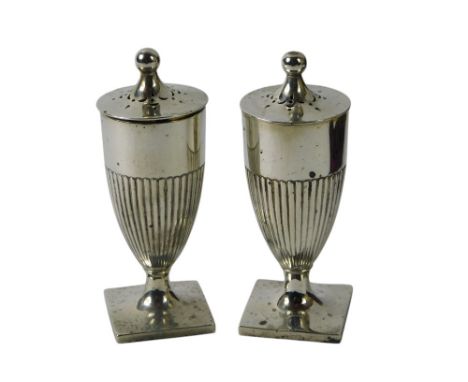 A pair of Victorian silver pepper pots, of urn form, with part fluted decoration on a square foot, London 1894, 2 1/4oz, 8cm 