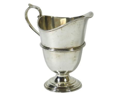 A late Victorian silver helmet-shaped cream jug, with a plain loop handle and domed foot, London 1897, 6.23oz, 12cm high.