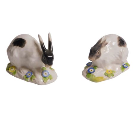 A pair of ceramic hares, in 18thC style, each on a flower-encrusted base, copies of Meissen originals by Johann Kandler, 10cm