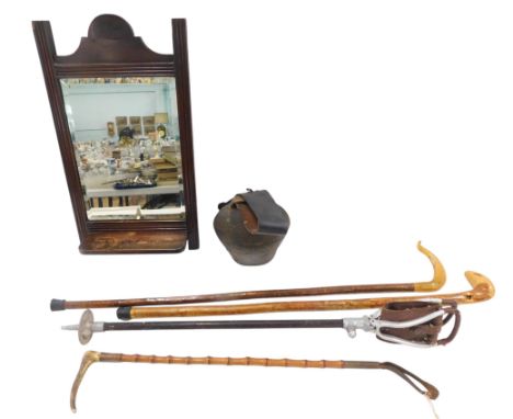 A large bronze cow bell, with leather strap, a wall mirror, shooting stick, etc.