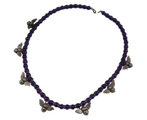 An amethyst bead necklace, set with silver bees at intervals, on a bolt ring clasp. 