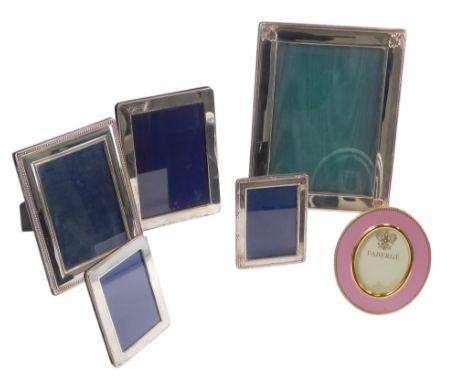 Various silver and silver plated photograph frames, various sizes, and a replica ceramic Faberge frame.
