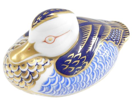 A Royal Crown Derby porcelain duck paperweight, printed mark in red to underside, lacking button, 7cm high.