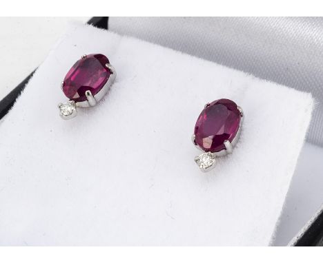 A pair of platinum ruby and diamond ear studs, the oval mixed cut rubies surmounted by brilliant cut diamonds, cased, rubies 