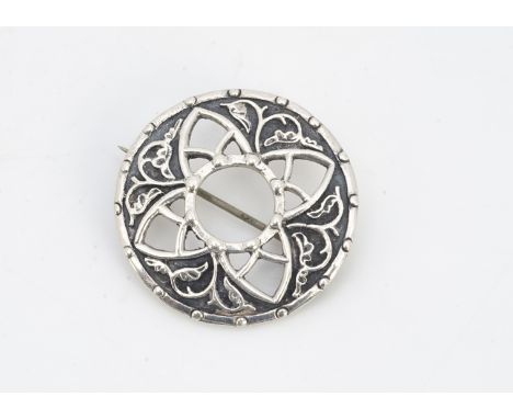 A contemporary silver iona Celtic brooch, designed by John Heart of circular design with pierced cruciform decoration, Edinbu