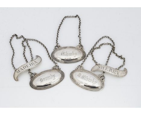 A pair of Georgian silver decanter labels, one for Madeira, the other sherry, together with a set of three Victorian silver d