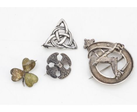 A collection of silver Celtic brooches, including a Connemara marble silver set clover leaf, a silver Celtic cross, silver Ce