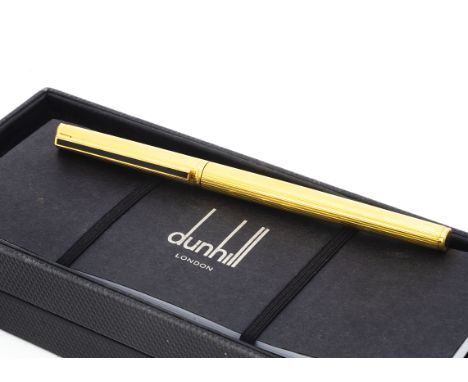 A Dunhill roller ball pen, gilt with black panel to clip, in box