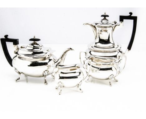 A George V silver four piece tea set by Walker &amp; Hall, comprising teapot, hot water, sugar basin and milk jug, Sheffield 