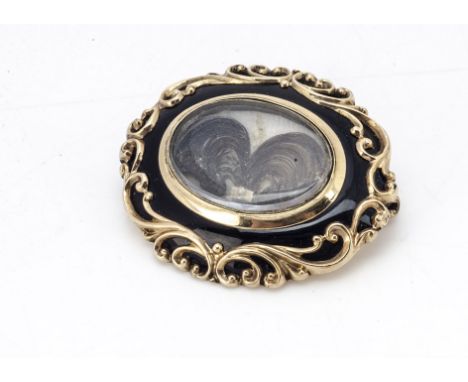 A Victorian yellow metal, enamel and plaited hair mourning brooch, of oval design, 4cm x 3.5cm, 15g