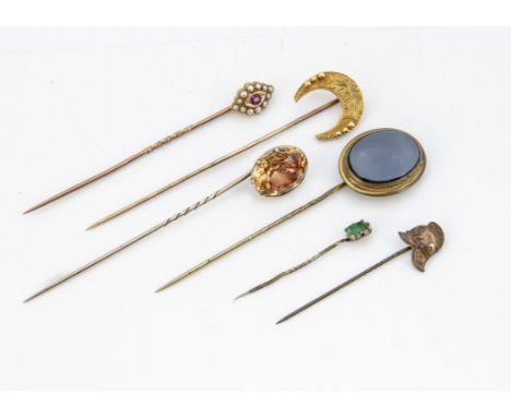 A collection of various stick pins, including a paste set foil backed example circa 1830, af, a yellow metal crescent, ruby a