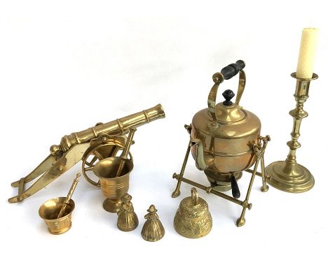 A brass kettle, canon, candlestick, and other items