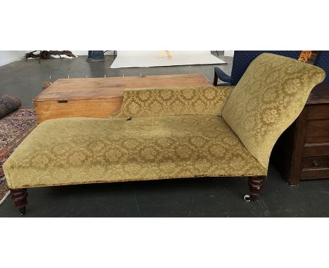 An early 20th century chaise longue on turned legs and ceramic casters