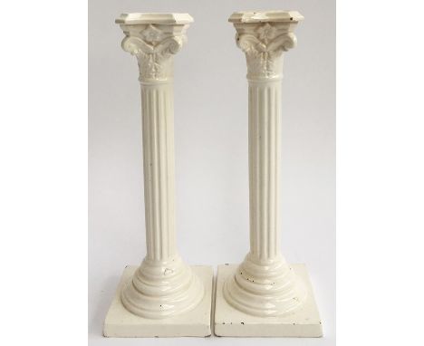 A 19th century pair of antique ceramic column candlesticks with makers mark to base