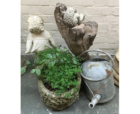 A vintage two gallon watering can, together with a composite stone figure, 57cmH, planter, and bird table with squirrel, 70cm